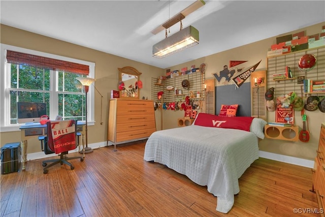 bedroom featuring baseboards and wood finished floors