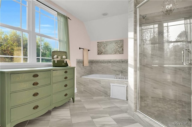 full bathroom with lofted ceiling, a garden tub, and a stall shower