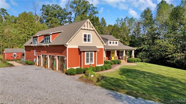 craftsman-style home with driveway, roof with shingles, an attached garage, covered porch, and a front lawn