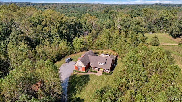 drone / aerial view with a wooded view