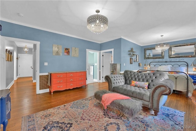 bedroom featuring a chandelier, dark wood-style flooring, ornamental molding, and baseboards