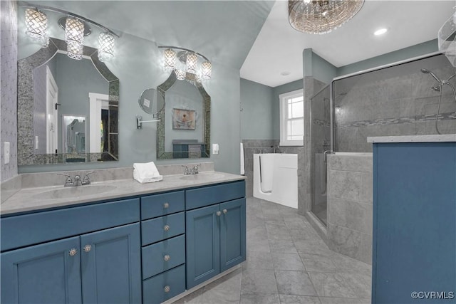 full bath with double vanity, a shower stall, and a sink