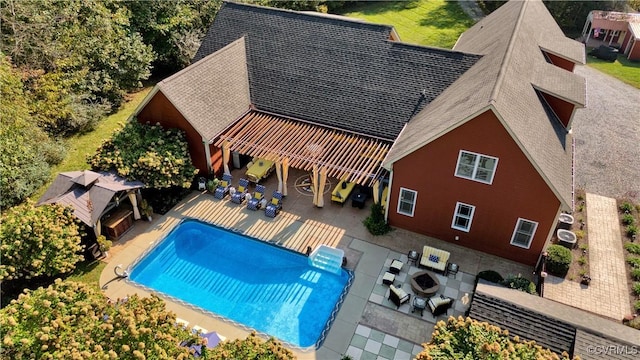 pool featuring a patio, a fireplace, and a pergola