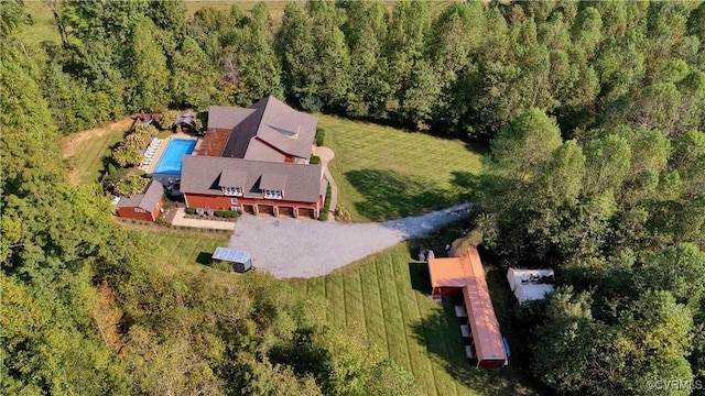 birds eye view of property with a forest view