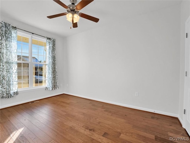 empty room featuring hardwood / wood-style flooring and ceiling fan