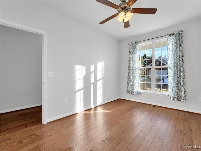 empty room featuring ceiling fan and wood-type flooring