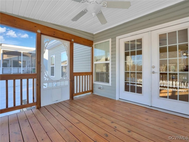 unfurnished sunroom featuring ceiling fan