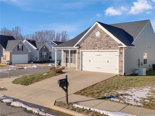 view of front of property featuring cooling unit and a garage