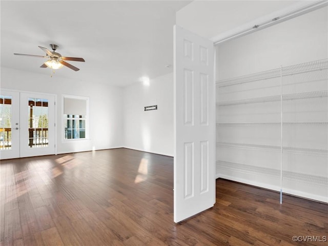 unfurnished living room featuring ceiling fan, french doors, and dark hardwood / wood-style floors