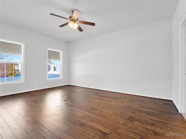 spare room featuring ceiling fan and dark hardwood / wood-style floors