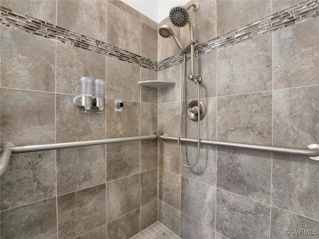 interior details featuring tiled shower