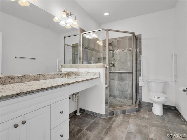 bathroom featuring a shower with shower door, sink, and toilet