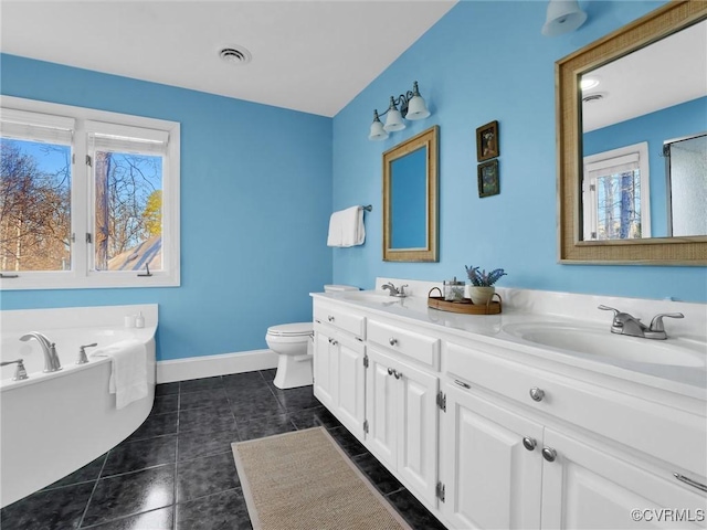 bathroom with vanity, a washtub, tile patterned floors, and toilet