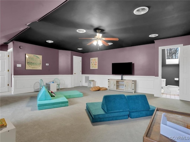 carpeted living room featuring ceiling fan