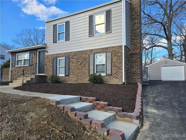 view of front of property with a garage and an outbuilding