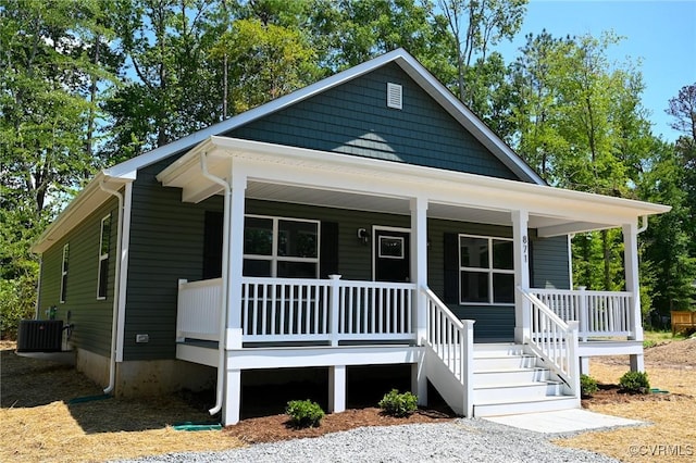 bungalow-style home featuring covered porch and cooling unit