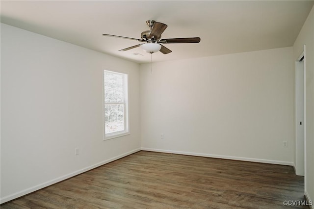 unfurnished room with ceiling fan and dark wood-type flooring