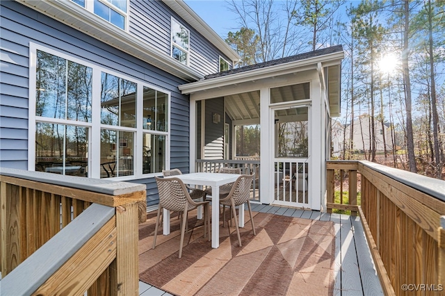 wooden deck featuring a sunroom