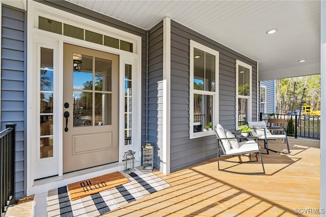 view of exterior entry featuring a porch