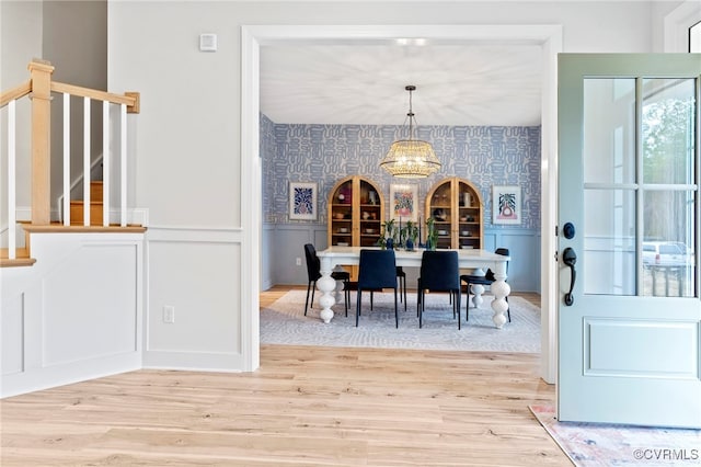 dining room with hardwood / wood-style floors and a notable chandelier