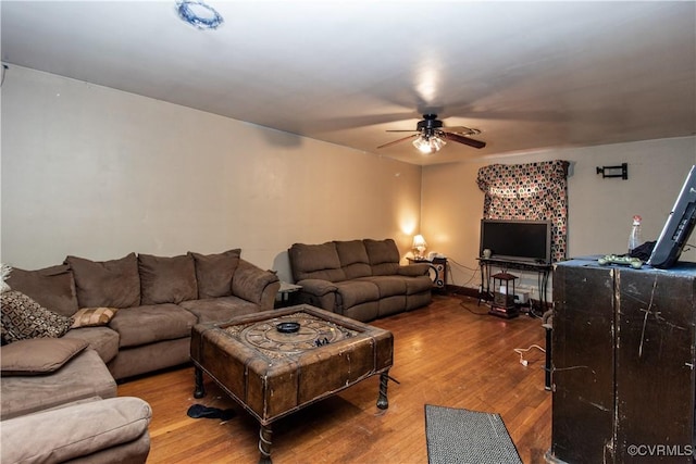 living room featuring ceiling fan and hardwood / wood-style floors