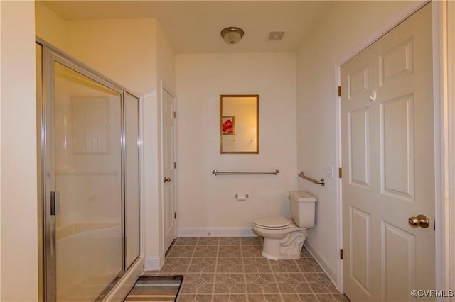 bathroom with toilet, a shower with door, and tile patterned flooring