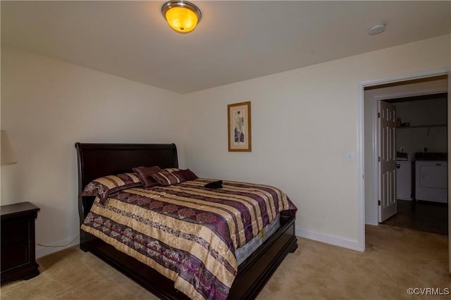 carpeted bedroom with separate washer and dryer