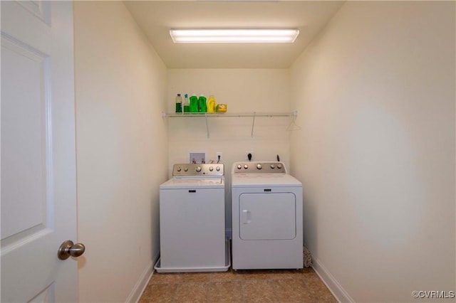 washroom with washing machine and clothes dryer