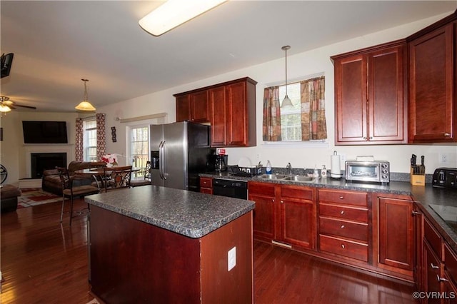 kitchen with pendant lighting, sink, black dishwasher, a center island, and stainless steel fridge with ice dispenser