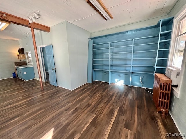 unfurnished room with radiator and dark hardwood / wood-style flooring