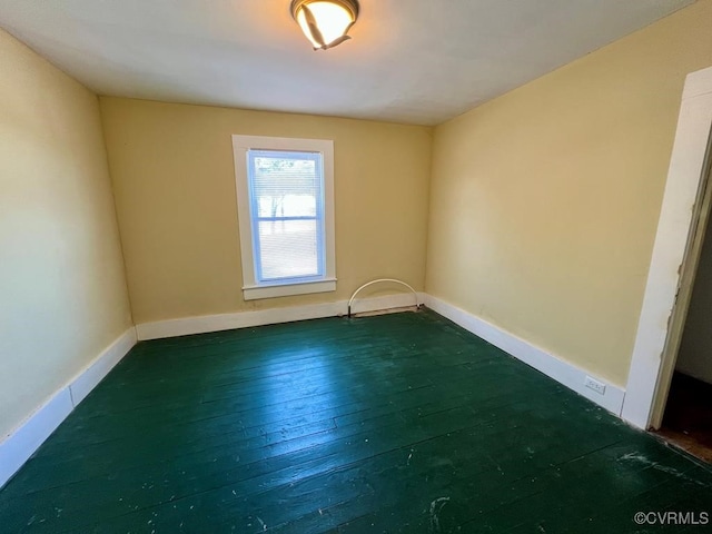 spare room with dark hardwood / wood-style flooring