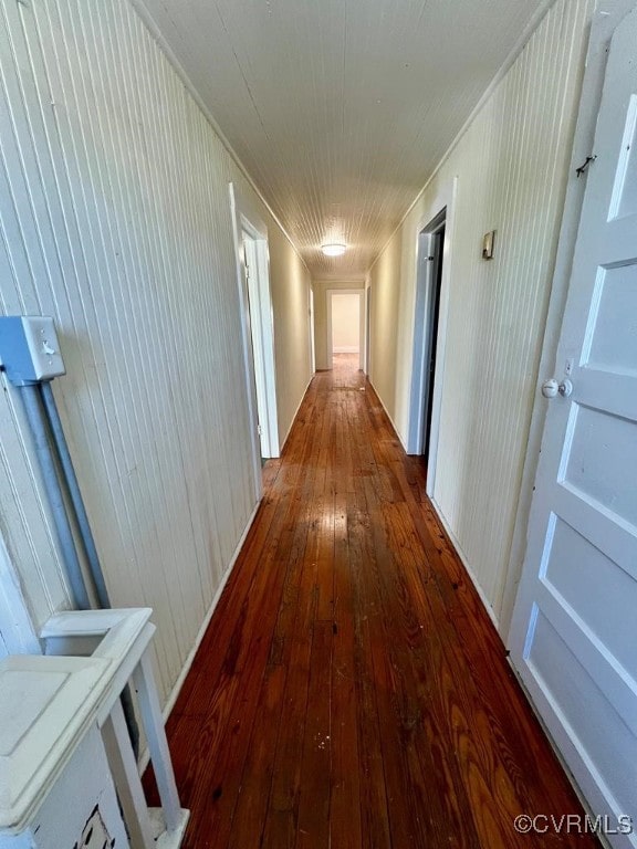 corridor featuring wood walls and hardwood / wood-style floors