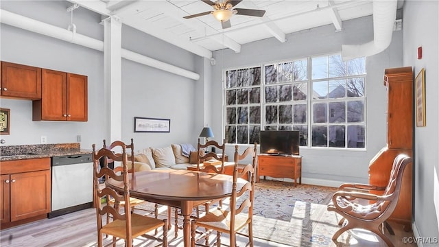 dining area with sink, ceiling fan, beamed ceiling, and light hardwood / wood-style floors