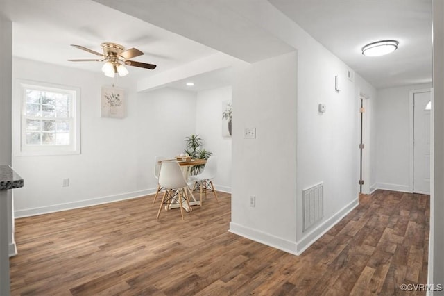 interior space with ceiling fan and dark wood-type flooring