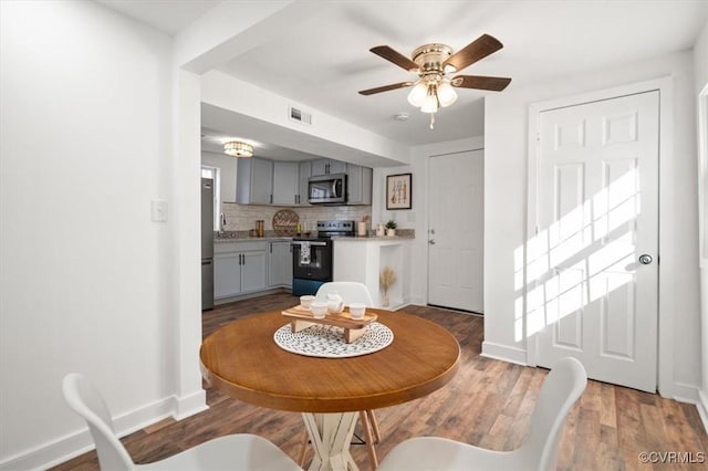 dining room featuring ceiling fan and wood-type flooring