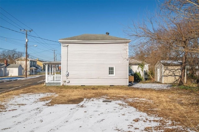 view of snowy exterior with covered porch