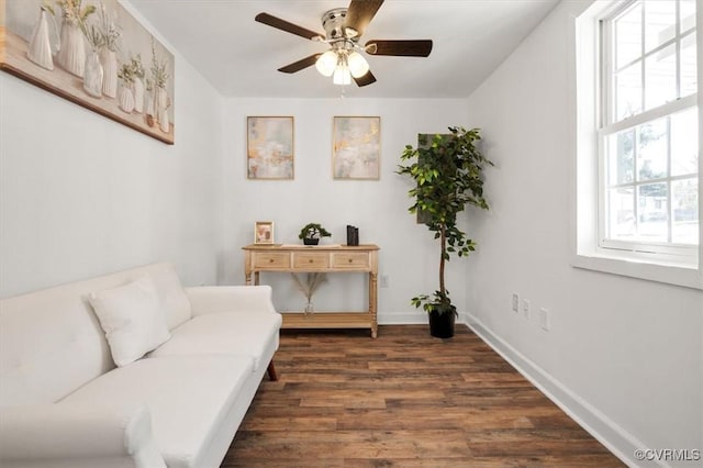 living area with ceiling fan and dark wood-type flooring