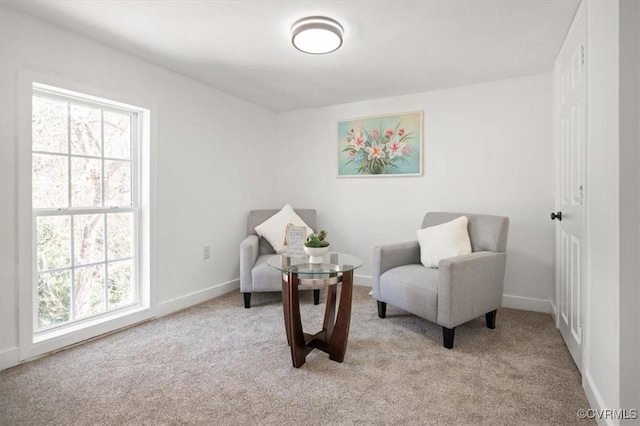 living area with light carpet and plenty of natural light