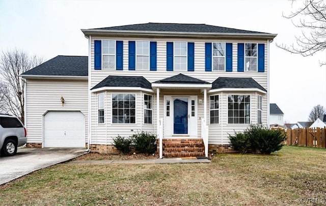 view of front of property with a garage and a front lawn