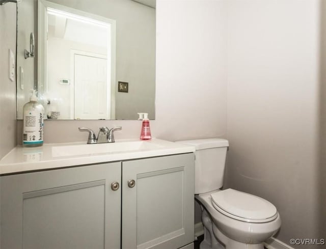 bathroom with toilet and vanity