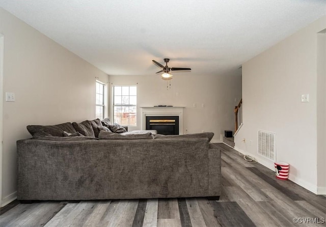 living room with ceiling fan and dark hardwood / wood-style floors