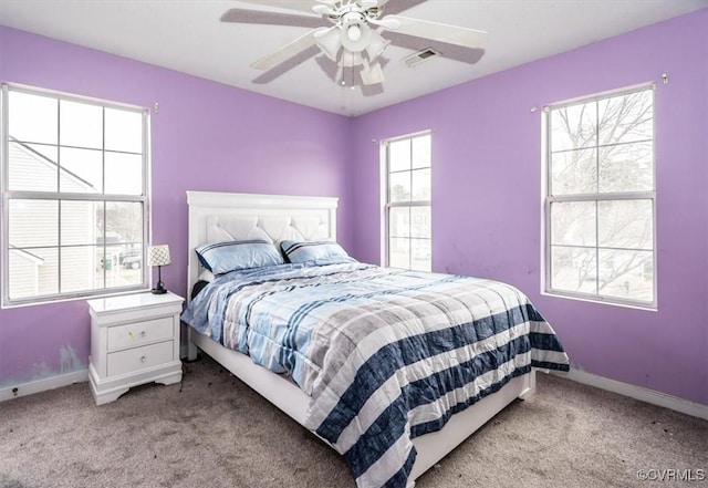 bedroom featuring ceiling fan and light carpet