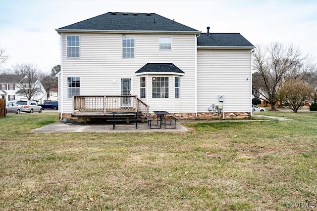 rear view of property with a deck, a yard, and a patio