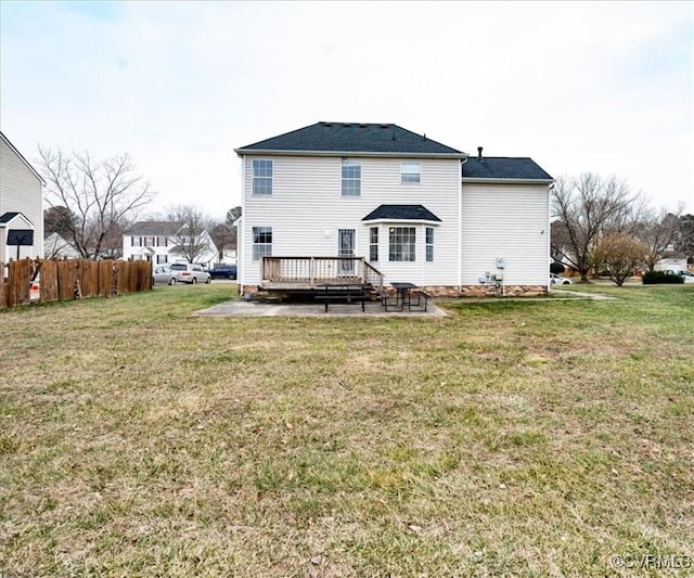 rear view of property with a wooden deck, a yard, and a patio