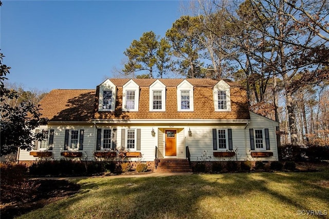 cape cod house with a front yard