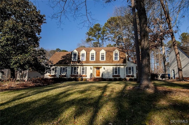 new england style home featuring a front yard