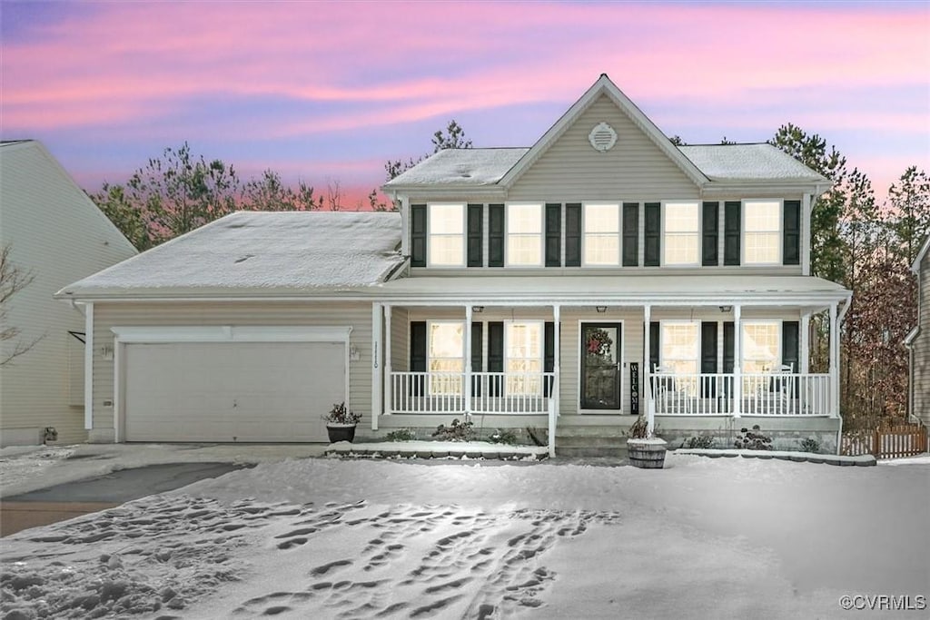 view of front of home featuring a porch and a garage