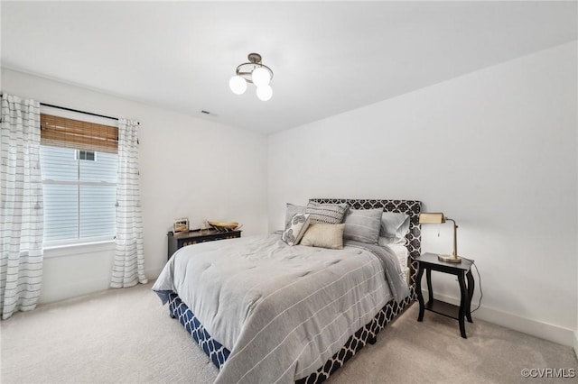 carpeted bedroom with baseboards and visible vents