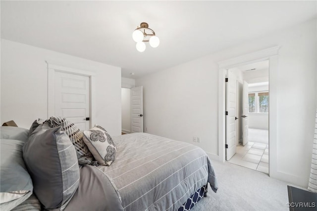 bedroom featuring baseboards and light colored carpet