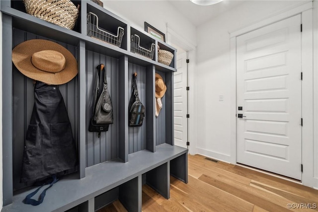 mudroom featuring baseboards and wood finished floors